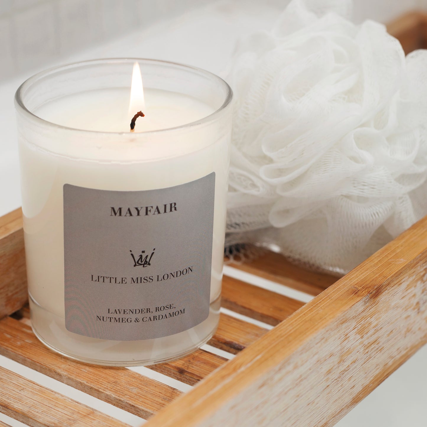 Little Miss Mayfair Candle lit on wooden stand