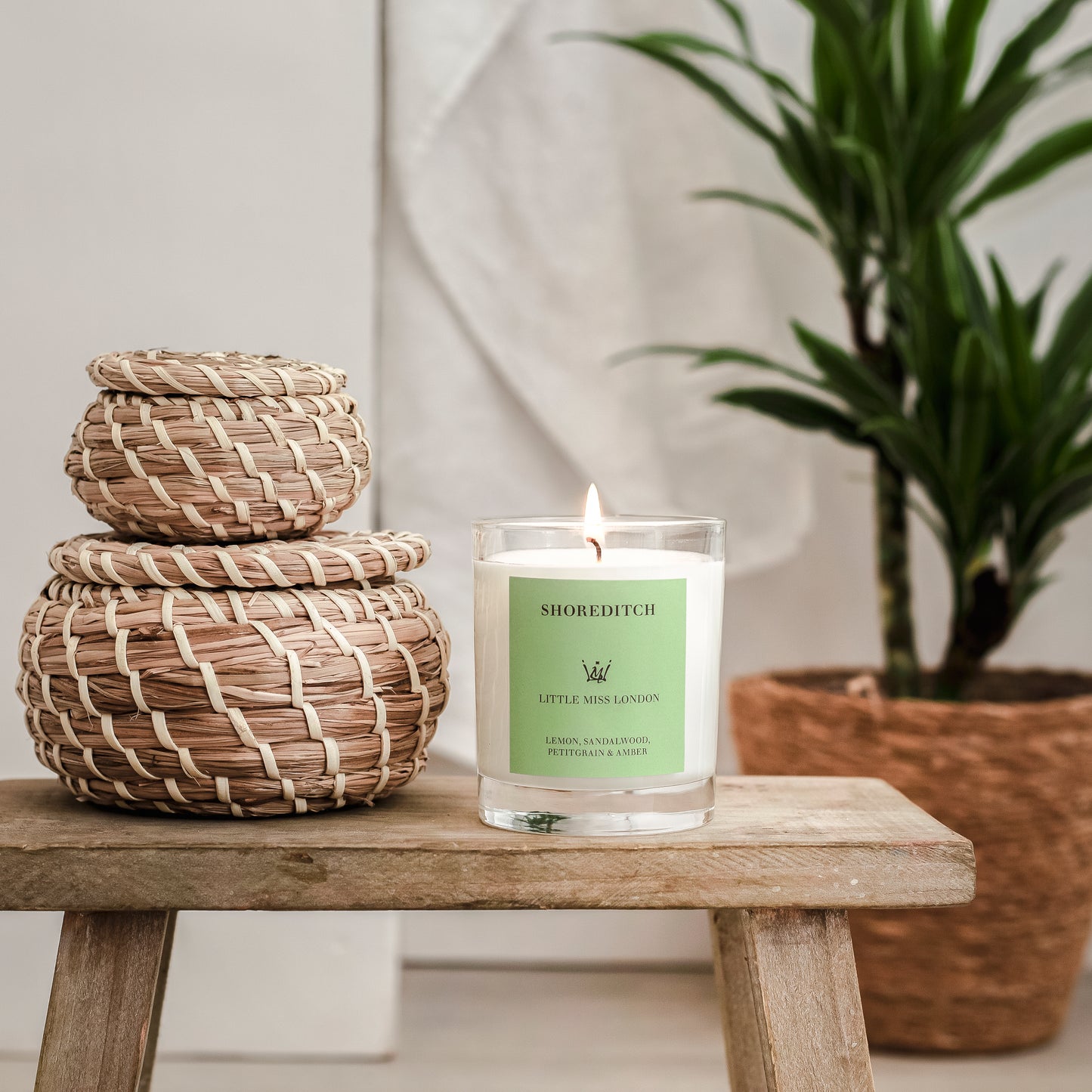 Little Miss Shoreditch Candle, lit on a wooden stool