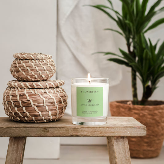 Little Miss Shoreditch Candle, lit on a wooden stool